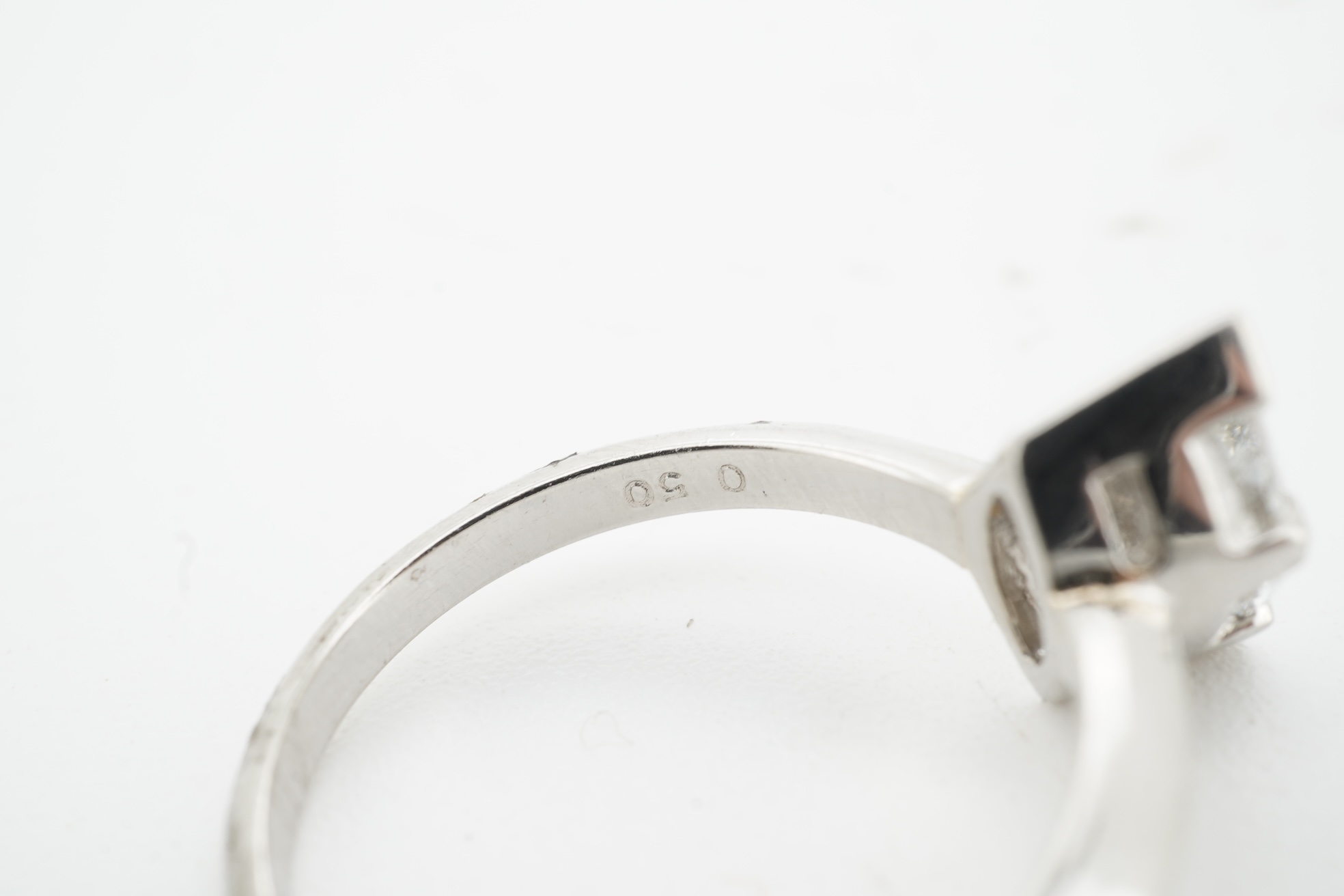 A diamond ring, claw-set with a marquise-shaped diamond weighing approximately 0.50 carats, mounted in platinum, size L, British hallmarks, gross weight approximately 4 grams